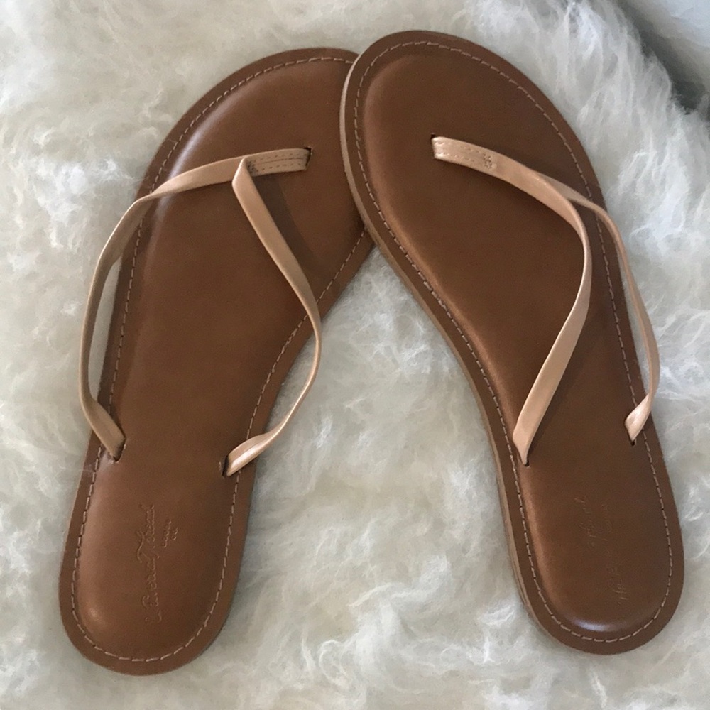 Neutral leather flip flops